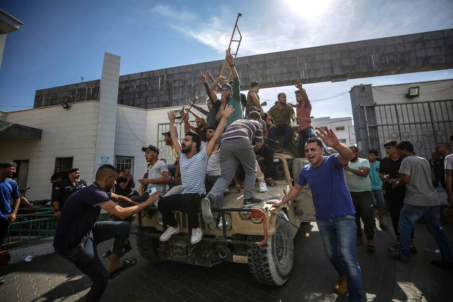 Palestinos se montan en un jeep militar israelí por las calles de Gaza durante el asalto a los asentamientos israelíes por parte de militantes de la milicia Ezz Al-Din Al Qassam, el ala militar del movimiento Hamás, Ciudad de Gaza, 7 de octubre de 2023.