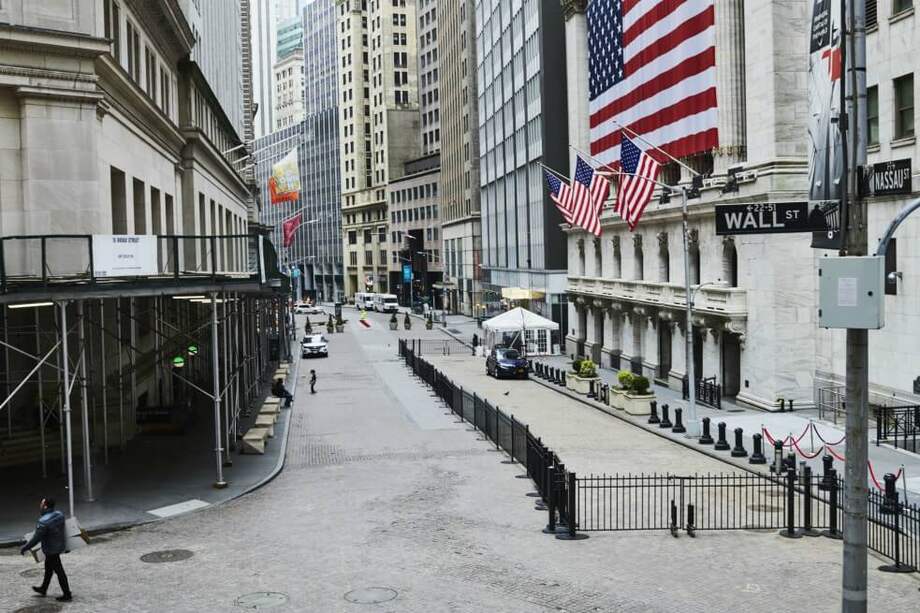 Pocos peatones circulan en la calle de Wall Street, en el distrito financiero de Nueva York (EE.UU.). / Bloomberg.