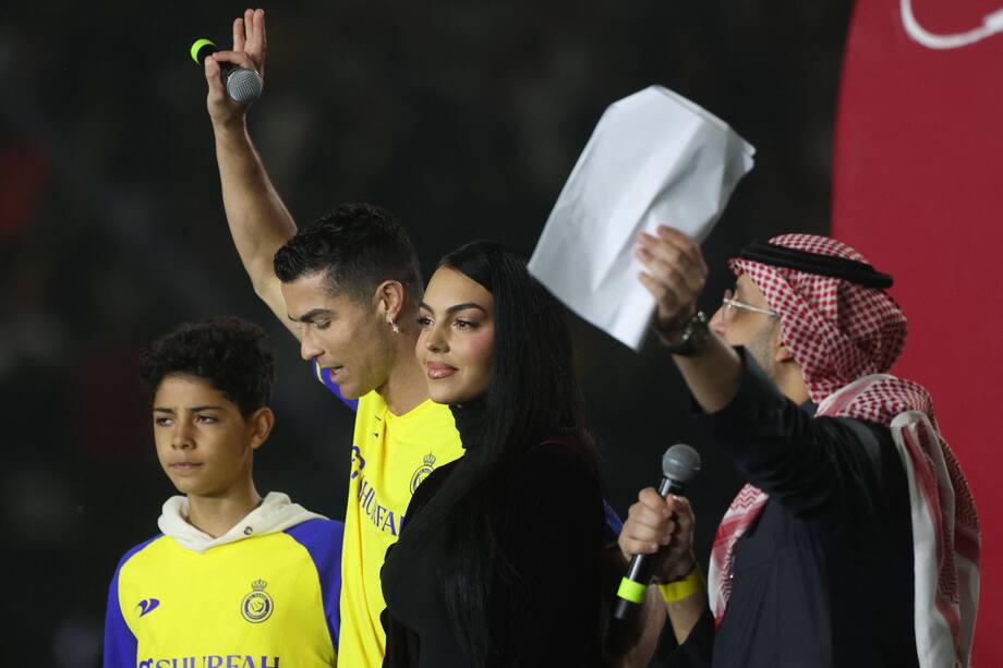 Al-Nassr's new Portuguese forward Cristiano Ronaldo (C-L), his partner Georgina Rodriguez (C-R) and his son Cristiano Ronaldo Jr (L) take the stage during the unveiling ceremony at the Mrsool Park Stadium in the Saudi capital Riyadh on January 3, 2023. (Photo by Fayez Nureldine / AFP)
