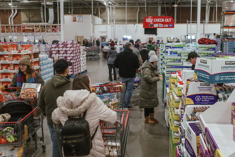 Shoppers wait in line at the cash registers at a grocery store in Lenexa, Kansas.