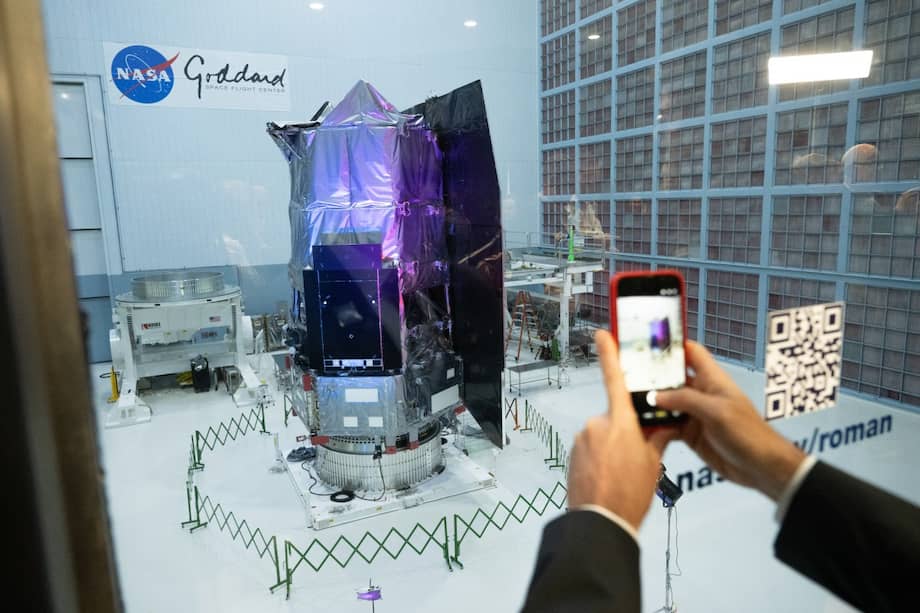 A journalist photographs the Nancy Grace Roman Space Telescope as it is unveiled to the public, at NASA's Goddard Space Flight Center in Greenbelt, Maryland on April 21, 2026. Named after NASA's first chief astronomer, the Nancy Grace Roman Space Telescope will have a field of view at least 100 times larger than Hubble's, potentially measuring light from a billion galaxies in its lifetime. It is expected to be launched in late 2026 or early 2027. (Photo by SAUL LOEB / AFP)
