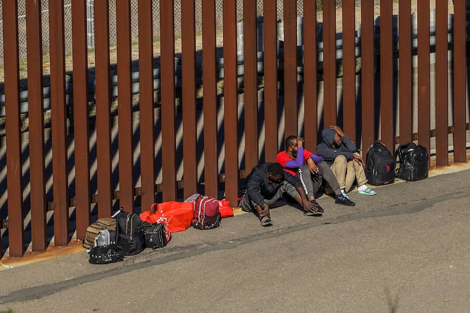 Migrantes permanecen a un costado del muro fronterizo con Estados Unidos, el 16 de noviembre de 2022, en Tijuana, Baja California (México).
