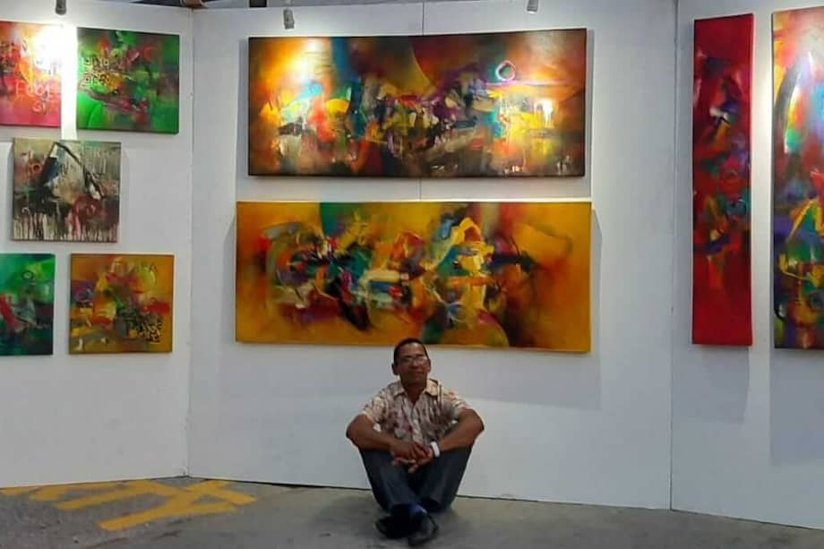 El artista Osby Cujia y de fondo su propuesta "La piel del Caribe", con la que participa en el Aruba Art Fear 2019. / Cortesía