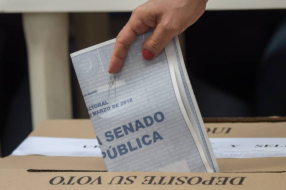 A woman casts her vote at a polling station in Bogota during parliamentary elections in Colombia, on March 11, 2018. Colombians went to the polls Sunday to elect a new Congress with a resurgent right, bitterly opposed to a peace deal that allows leftist former rebels to participate, expected to poll strongly. The election is set to be the calmest in half a century of conflict in Colombia, with the former rebel movement FARC spurning jungle warfare for politics, and the ELN -- the country's last active rebel group -- observing a ceasefire.
/ AFP / Raul ARBOLEDA
