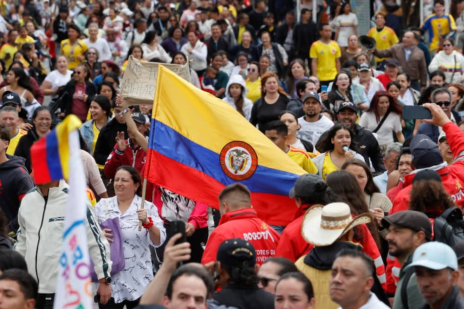 Personas observan el desfile militar con motivo del Día de la Independencia de Colombia este lunes, en Bogotá.