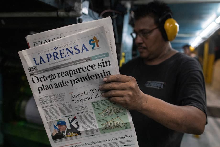 worker at La Prensa newspaper checks a paper during the printing process in Managua