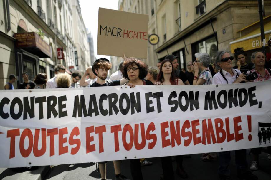Manifestantes sostienen una pancarta que dice "contra Macron y su mundo, todos juntos" en París, Francia. / EFE