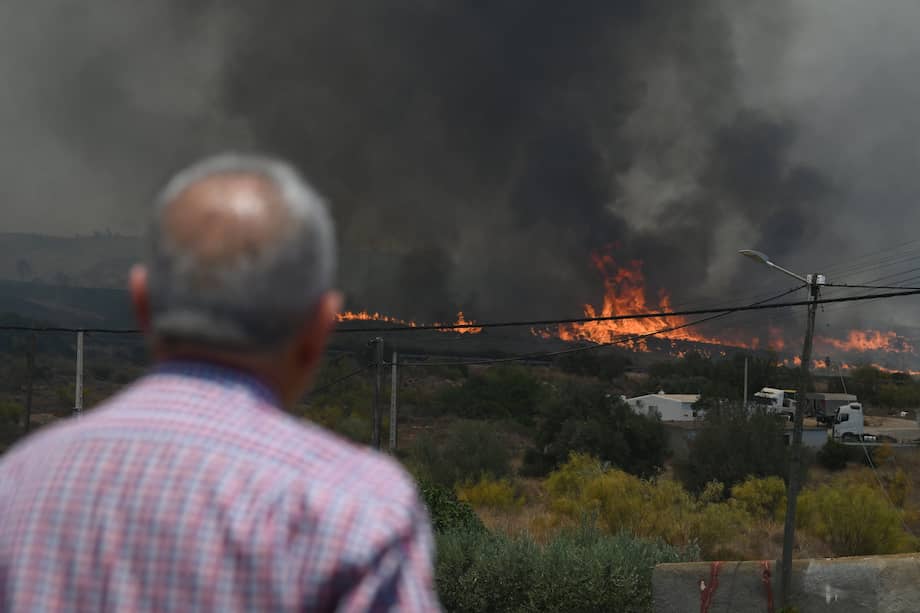 Un hombre observa las llamas cerca de las casas, en la zona afectada por un incendio forestal que dejó 11 muertos cerca de Bedar, en el distrito de Los Gallardos, en Almería.
