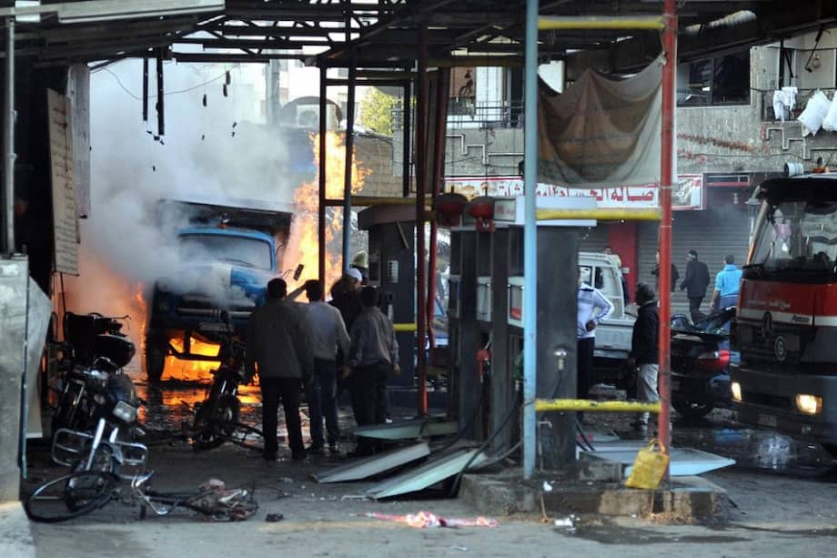 Grupo de sirios observando el escenario de un ataque con coche bomba en Yarmana. Foto: EFE