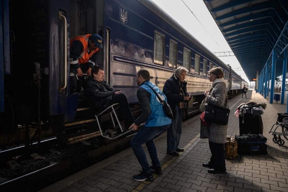Desplazados internos de Ucrania abordan un tren de evacuación que parte hacia Lviv, el día después de llegar como parte de un convoy humanitario desde la ciudad sitiada de Mariúpol.