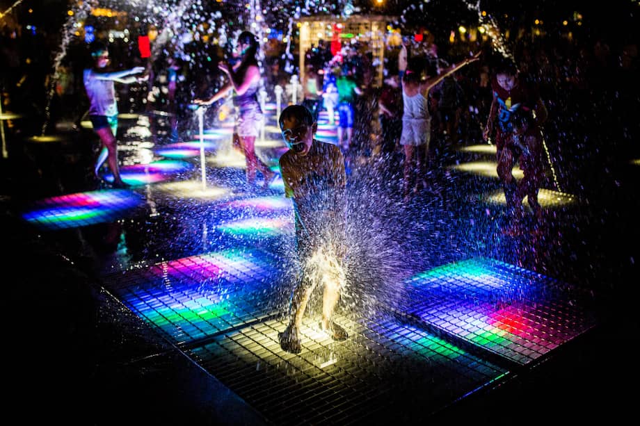 La Fuente de los Niños juega con luces de colores y chorros de agua aleatorios. / Getty Images