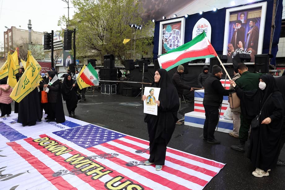 Durante una manifestación para conmemorar el Día Internacional de Al-Quds en Teherán, los iraníes pisotean pancartas con las banderas de Estados Unidos e Israel.