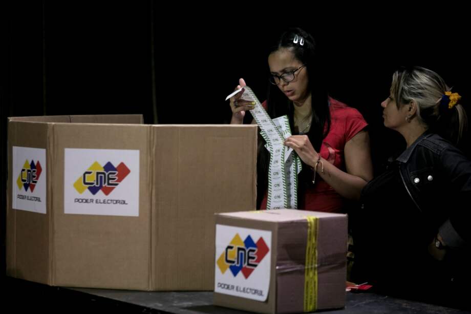 Miembros de mesa cierran y auditan un centro de votación durante las elecciones municipales en Caracas (Venezuela). / EFE