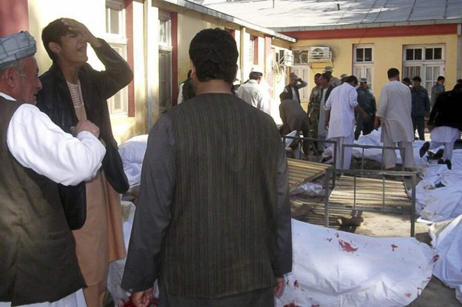 Familiares lloran junto a los cadáveres de las víctimas del un atentado suicida en Maymana/ EFE