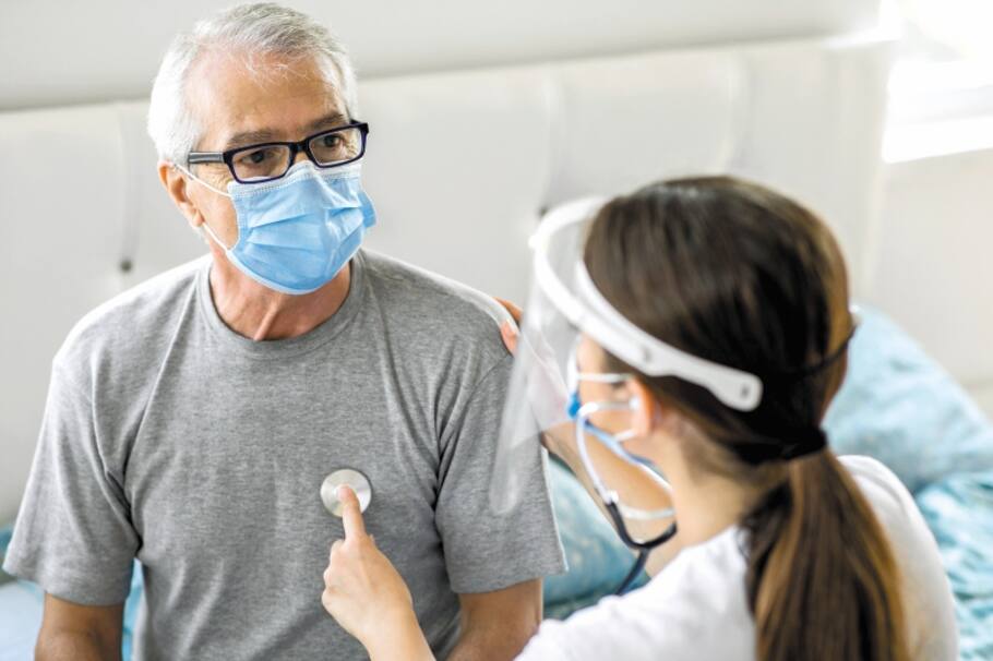 Health visitor and a senior man during home visit