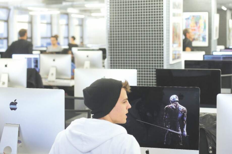 Students works in the Ecole 42 digital school, founded by provider of phone, Internet and TV services group Iliad SA's chairman Xavier Niel, Tuesday Oct.27, 2015 in Paris. (AP Photo/Thibault Camus)