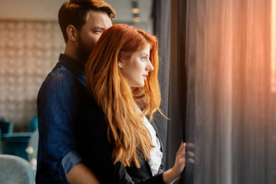 Pareja mirando por la ventana