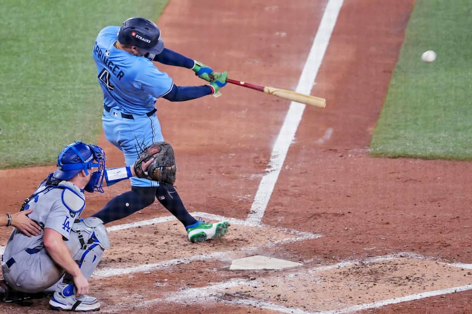 Toronto Blue Jays designated hitter George Springer (R) hits an RBI single against the Los Angeles Dodgers during the third inning of game six of the MLB World Series between the Los Angeles Dodgers and the Toronto Blue Jays in Toronto, Canada, Oct. 31, 2025.
