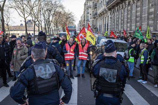 Protesters in Paris gather in front of the National Assembly to demonstrate their rejection of the pension reform.  Since January, thousands of French people have protested against changes to the pension regime that Macron has proposed.