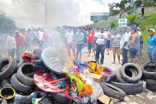 Residents of the Brazilian border town of Pacaraima burn tyres and belongings of Venezuelans immigrants after attacking their two main makeshift camps, leading them to cross the border back into their home country on August 18, 2018. Brazil will send troops to its border with Venezuela on Monday after residents of Pacaraima drove out Venezuelan immigrants from their improvised camps, amid growing regional tensions. Tens of thousands of Venezuelans have crossed the border into Brazil over the past three years as they seek to escape the economic, political and social crisis gripping their country. / AFP / Isac DANTES