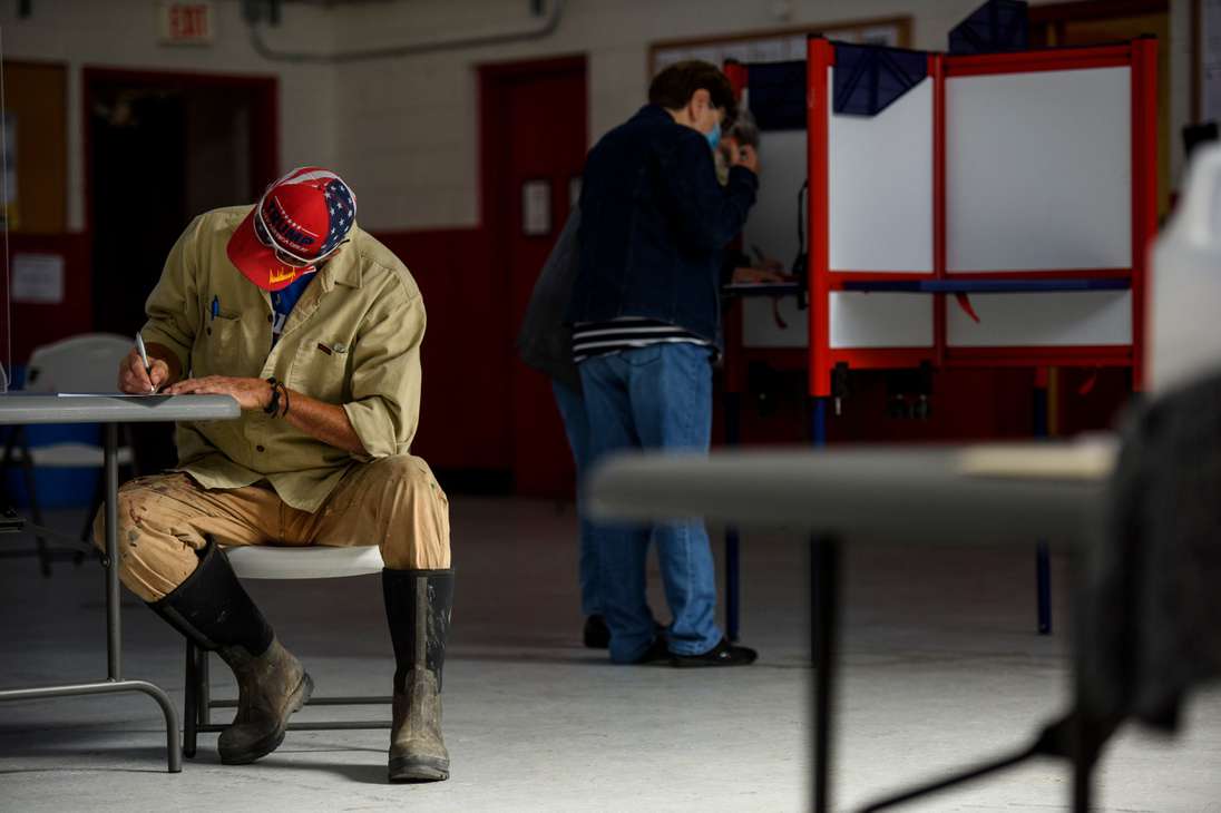 ST PAULS, NC - NOVEMBER 03: A man fills out his ballot at the St. Paul's National Guard Armory on Election Day on November 3, 2020 in St. Pauls, North Carolina. After a record-breaking early voting turnout, Americans head to the polls on the last day to cast their vote for incumbent U.S. President Donald Trump or Democratic nominee Joe Biden in the 2020 presidential election.   Melissa Sue Gerrits/Getty Images/AFP