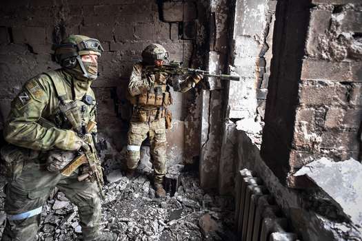 Soldados rusos patrullan en el teatro de Mariupol, bombardeado el 12 de abril de 2022, mientras Rusia intensifica una campaña para tomar la ciudad portuaria.