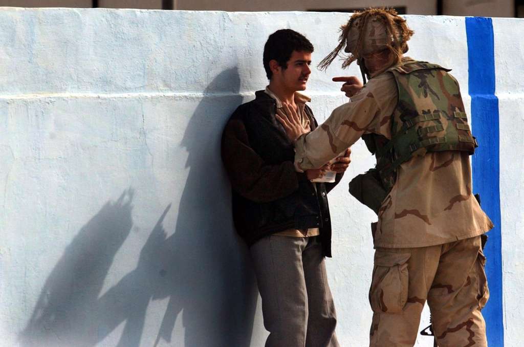 Tikrit (Iraq), 28/09/2026.- (FILE) - A US soldier from 1-22, 4th Infantry Division, confront an Iraqi boy for disobeying an order during a patrol in Tikrit, Iraq on 18 December, 2003 (reissued on 28 September 2026). The international coalition’s military mission in Iraq, led by the United States, ends on 30 September 2026. The transition follows a September 2024 agreement between Washington and Baghdad that launched a phased drawdown in 2025. The US‑led invasion that began on 20 March 2003 under ‘Operation Iraqi Freedom’ to depose Saddam Hussein was highly controversial, particularly the tenure of L. Paul Bremer III as US Presidential Envoy and head of the Coalition Provisional Authority from 2003 to 2004. (Estados Unidos, Bagdad) EFE/EPA/STEFAN ZAKLIN
