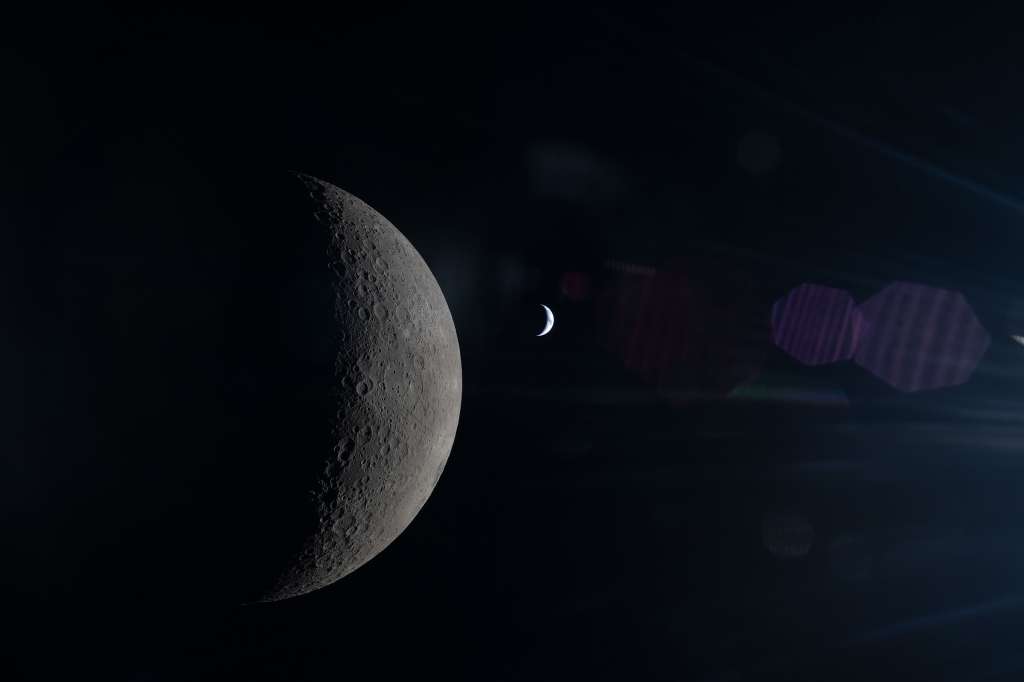 Una fotografía proporcionada por la NASA muestra la Luna y la Tierra alineadas en el mismo encuadre, ambas parcialmente iluminadas por el Sol, tal como se observa desde detrás de la Luna durante el vuelo Artemis II en abril. Estados Unidos aspira a tener un reactor en la Luna para 2030.