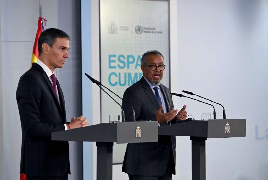 Spain's Prime Minister Pedro Sanchez (L) listens as World Health Organization (WHO) Director-General Tedros Adhanom Ghebreyesus speaks during a press conference at the Moncloa Palace in Madrid on May 12, 2026.