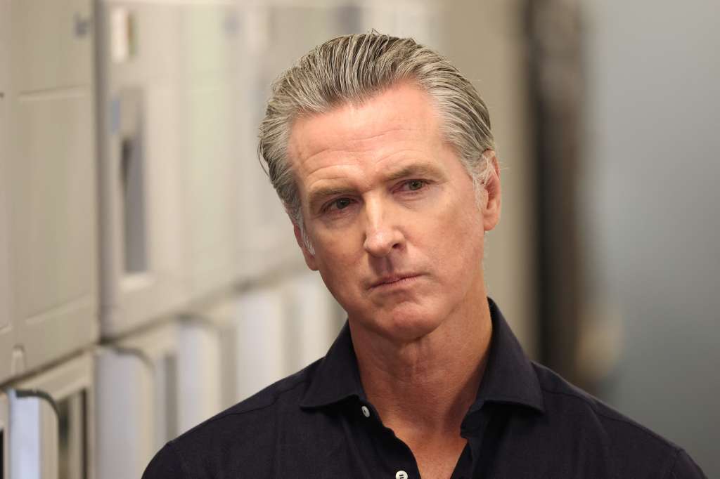 (FILES) California Governor Gavin Newsom listens before speaking during a press conference announcing $11 insulin and prescription drugs with the CalRX program inside a Cedars-Sinai pharmacy in Los Angeles, California on October 16, 2025.