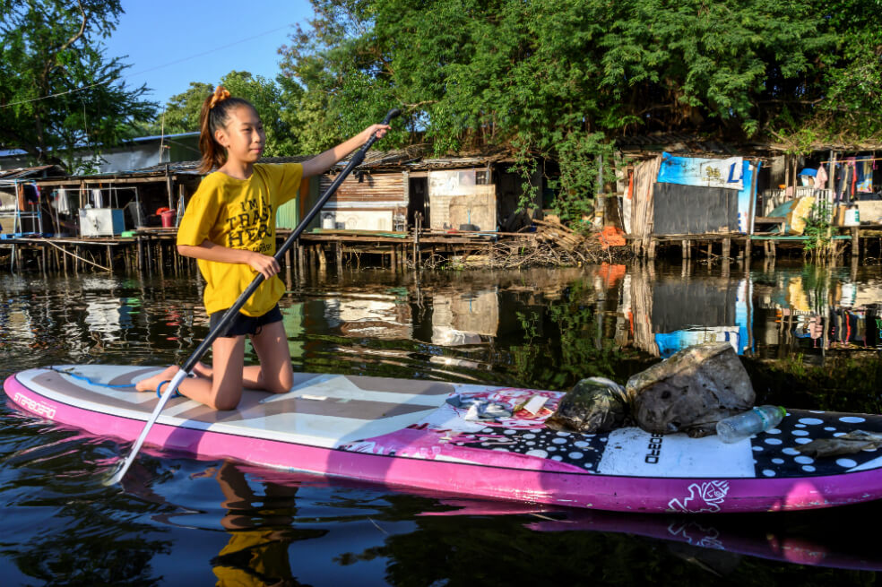 Lilly rema para recoger desechos plásticos en un canal en Bangkok. Tailandia es el sexto mayor contribuyente mundial a la contaminación del océano. / AFP