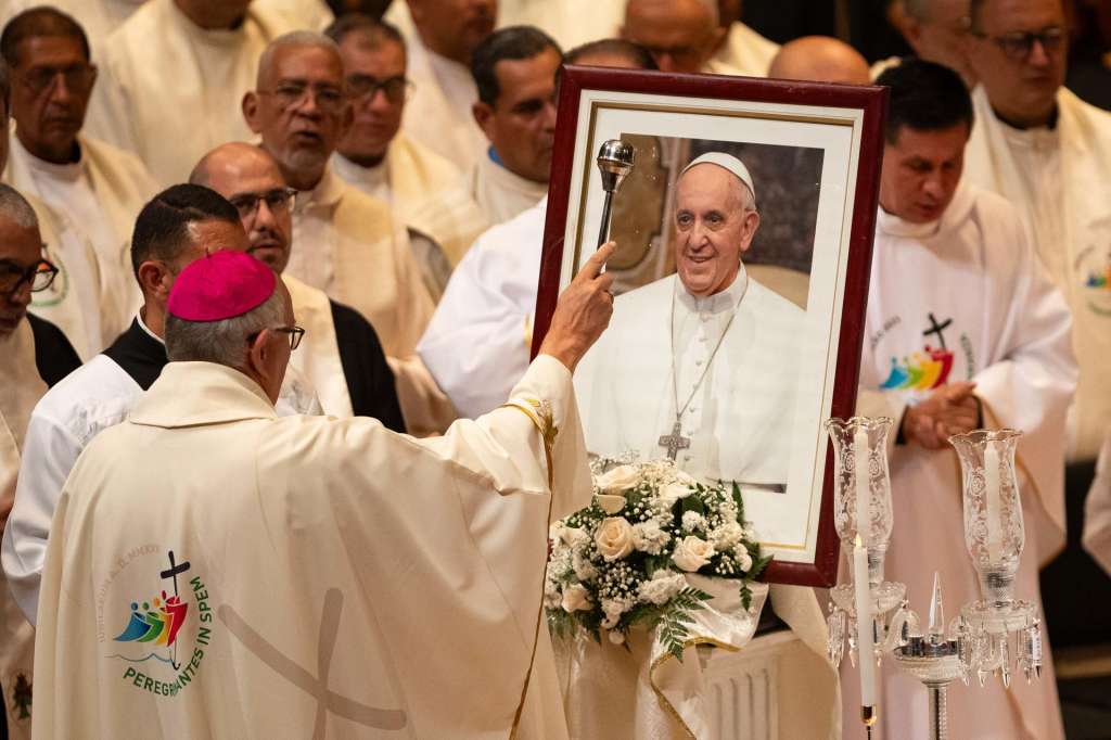 CARACAS (VENEZUELA), 26/04/2025.- El arzobispo de Caracas, monseñor Raúl Biord, rocía con agua bendita un retratro del papa Francisco durante una misa este sábado, en el Teatro Teresa Carreño en Caracas (Venezuela). La Iglesia de Venezuela despidió este sábado en Caracas al papa Francisco en una misa funeral celebrada en el Teatro Teresa Carreño, donde el nuncio apostólico del país, monseñor Alberto Ortega, afirmó que al pontífice se le recordará como un "peregrino de esperanza". EFE/ Ronald Pena R