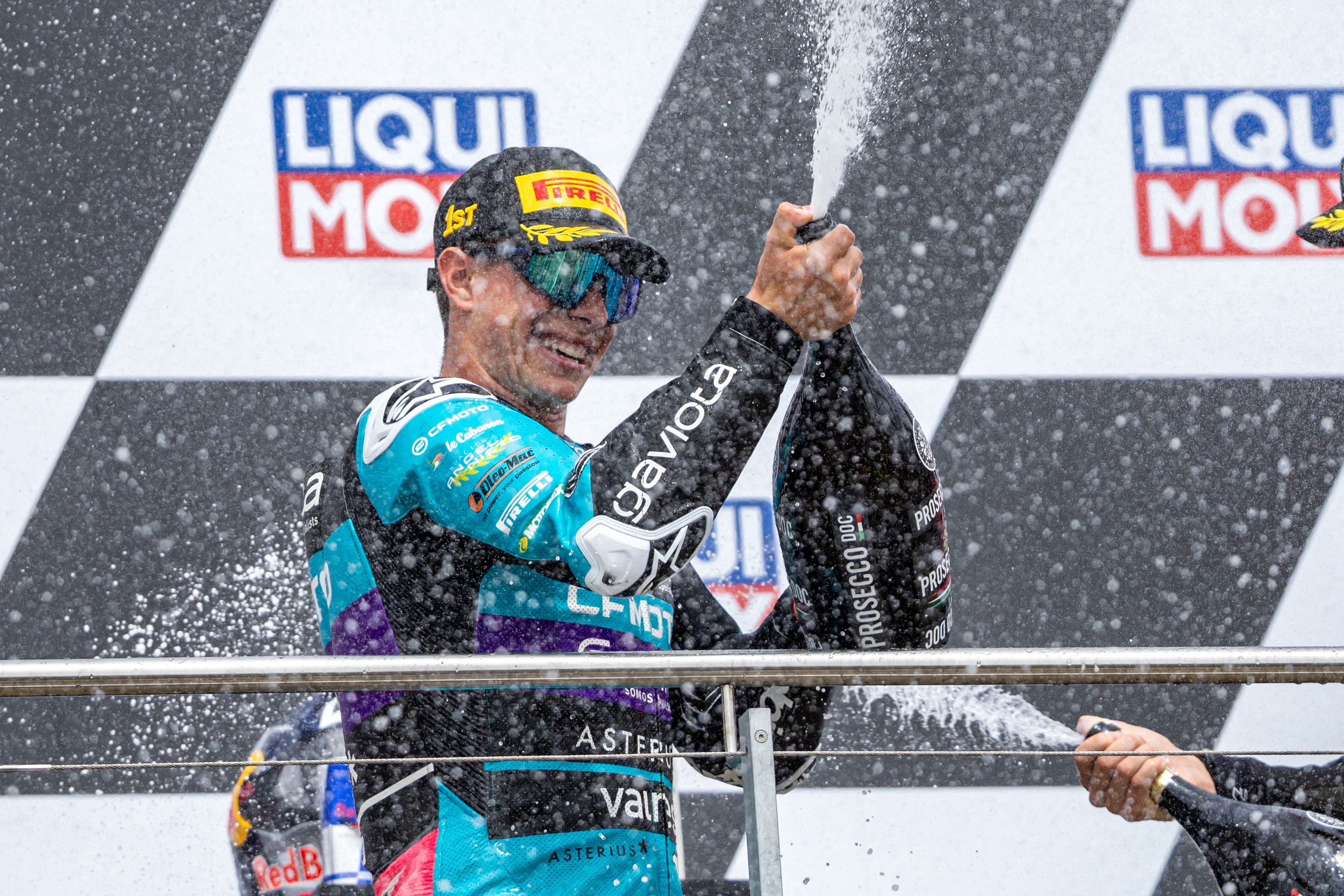 Hohenstein-ernstthal (Germany), 07/07/2024.- CFMOTO rider David Alonso of Colombia celebrates on the podium after winning the Moto3 race of the Motorcycling Grand Prix of Germany, at the Sachsenring racetrack in Hohenstein-Ernstthal, Germany, 07 July 2024. (Motociclismo, Ciclismo, Alemania) EFE/EPA/MARTIN DIVISEK