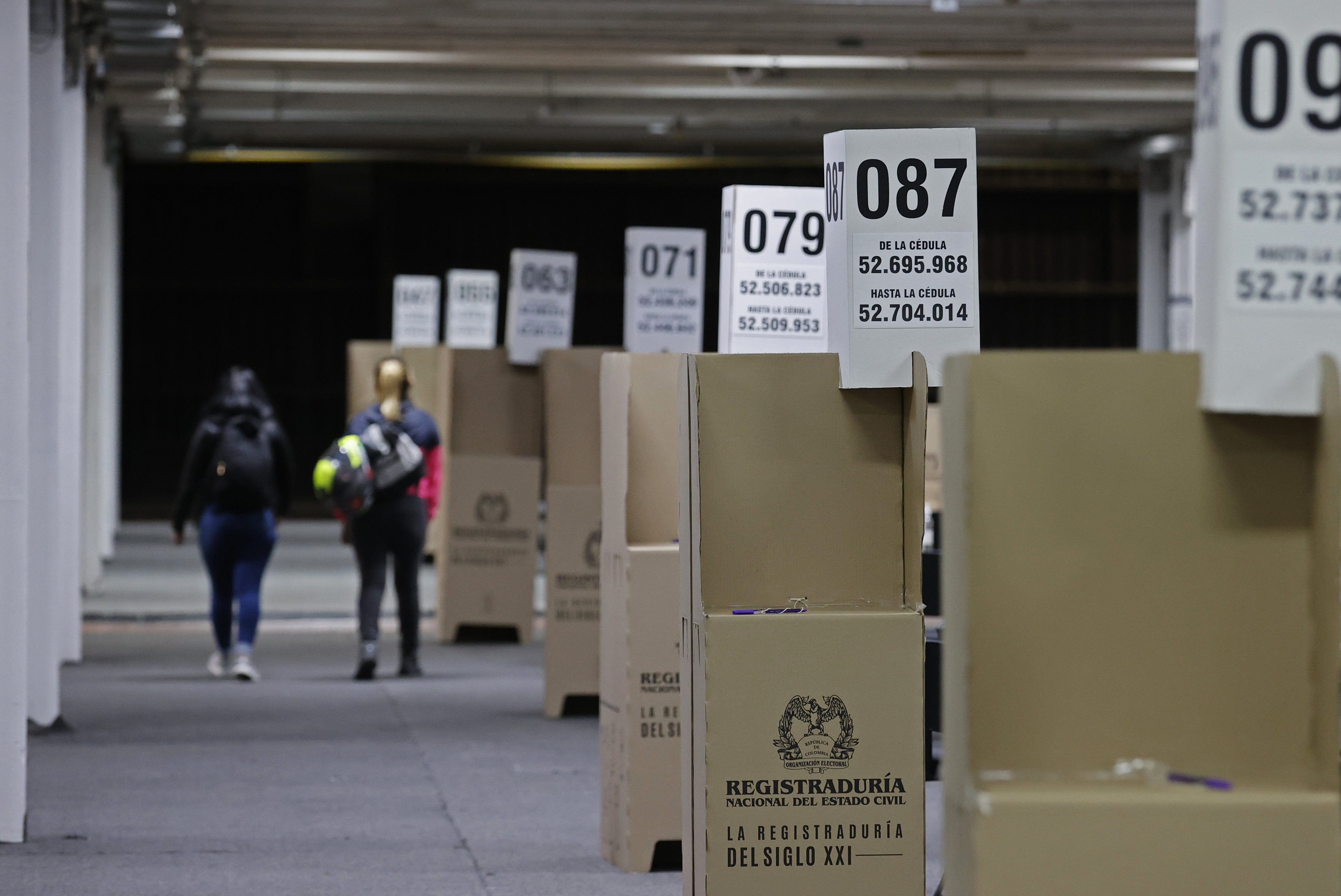 (COLOMBIA), 28/05/2022.- Dos mujeres caminan frente a puestos de votación hoy, en el recinto de Corferias en Bogotá (Colombia). Colombia realizará elecciones presidenciales este domingo para elegir al sucesor de Iván Duque. EFE/ Mauricio Dueñas Castañeda