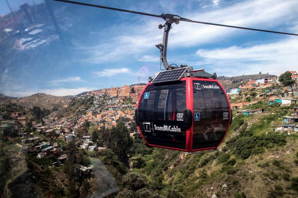 A "TransMiCable" cable car carriage passes above Ciudad Bolivar neighbourhood in Bogota on April 14, 2024.