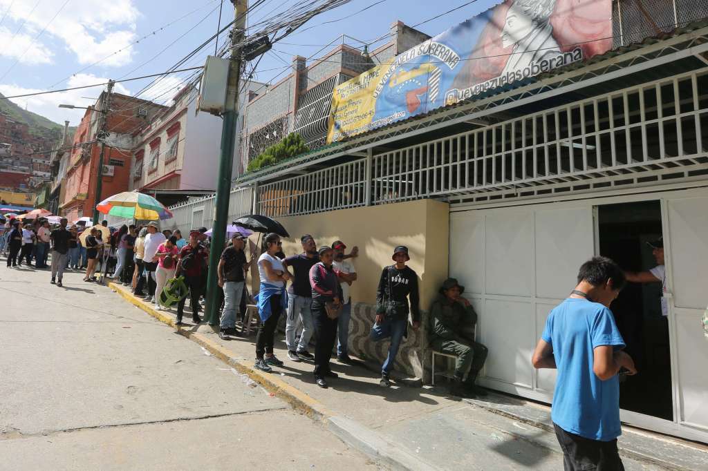 AME5831. CARACAS (VENEZUELA), 28/07/2024.- Personas esperan en una final de un puesto de votación este domingo, en Caracas (Venezuela). EFE/ Manuel Díaz