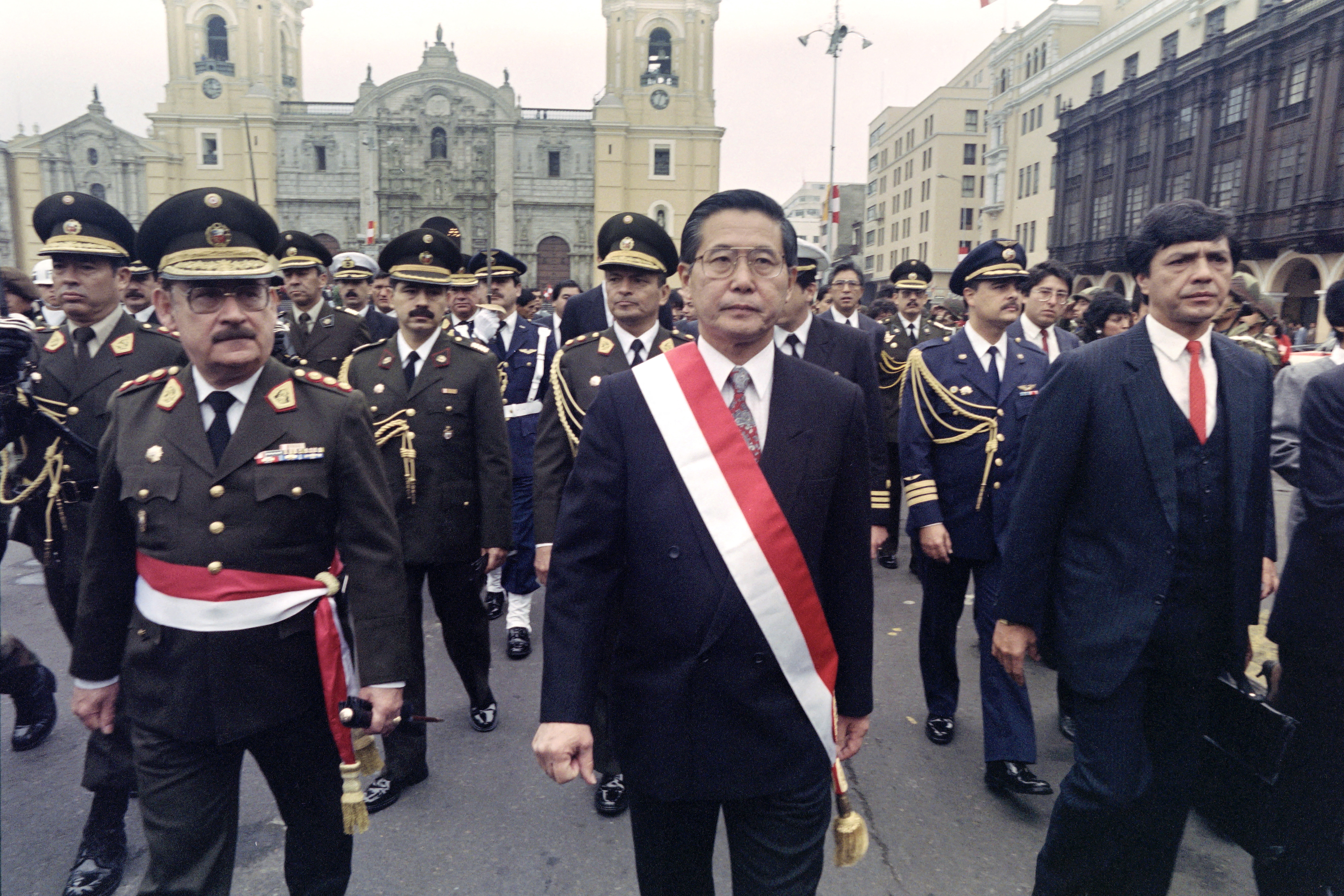 (FILES) Peruvian President Alberto Fujimori leads armed forces commanders during a military ceremony in Lima on July 28, 1991.