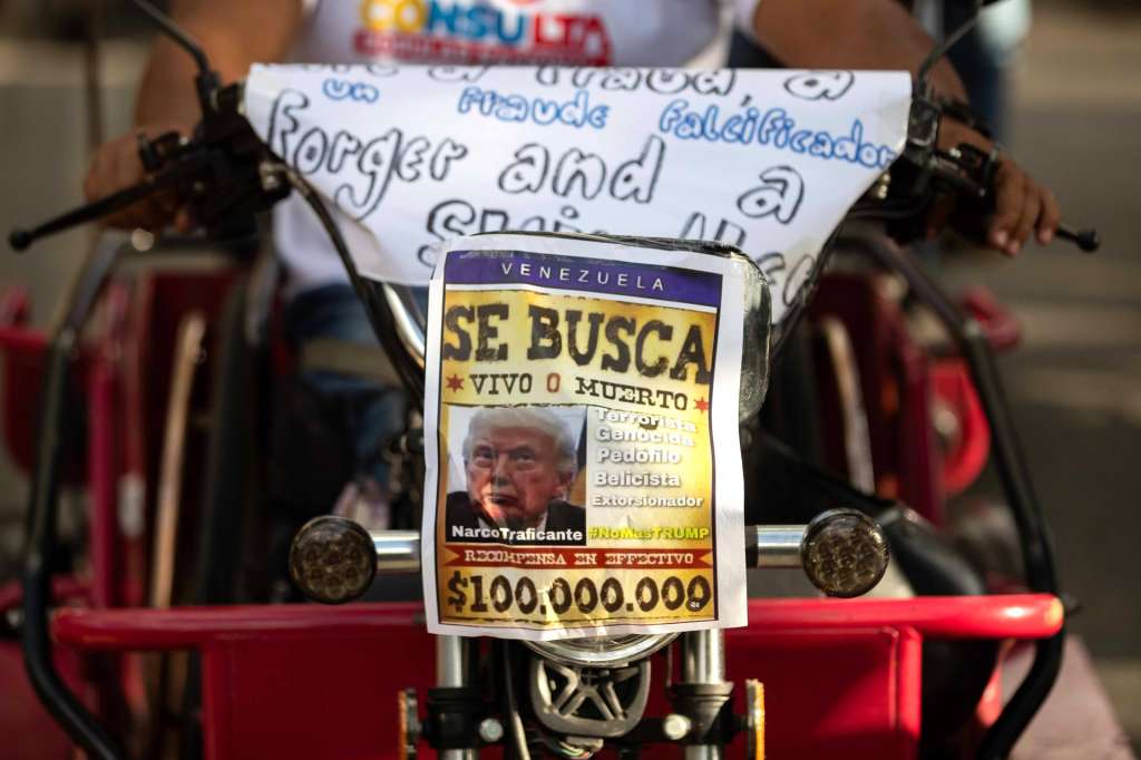 AME102. CARACAS (VENEZUELA), 22/12/2025.- Fotografía que muestra un cartel con la imagen del presidente de los Estados Unidos, Donald Trump, durante una caravana de motociclistas este lunes, en Caracas (Venezuela). Cientos de motoristas simpatizantes del chavismo, algunos disfrazados de piratas, recorrieron varias zonas de Caracas en protesta por la confiscación de dos buques con petróleo venezolano por parte de Estados Unidos y exhibieron afiches con la imagen del presidente Donald Trump con sombrero y parche. EFE/ Ronald Pena R