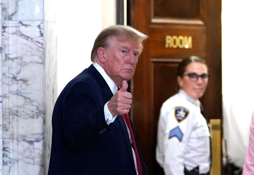 Former US President Donald Trump gestures as he returns from a break at the New York State Supreme Court during the civil fraud trial against the Trump Organization, in New York City on December 7, 2023. Former US president Donald Trump was back in court on December 7, 2023, for his New York civil trial on fraud allegations, once again condemning the process as unfair. Trump, the frontrunner for the 2024 Republican presidential nomination, and his two eldest sons are accused of inflating the value of their real estate assets to receive more favorable bank loans and insurance terms. (Photo by TIMOTHY A. CLARY / AFP)