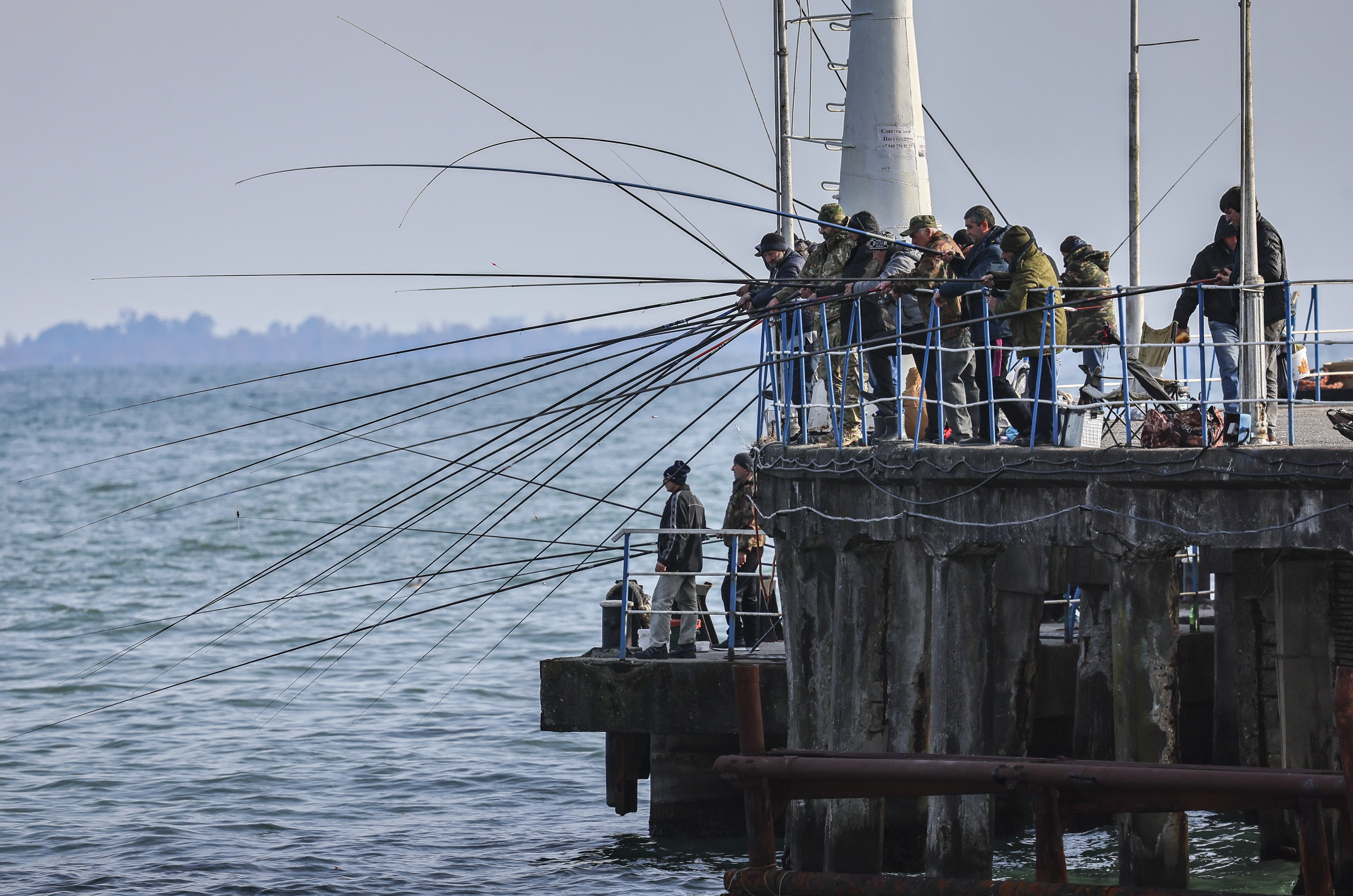 Sukhumi (Georgia), 11/03/2025.- Local people fish on the Black Sea in Sukhumi, the capital of the self-proclaimed republic of Abkhazia, 02 March 2025 (issued 11 March 2025). Abkhazia, a breakaway territory of Georgia since 2008 and recognized by a limited number of countries, including Russia, relies on tourism as a key economic driver. Its Black Sea coastline, with its mild climate and Soviet-era sanatoriums, continues to attract primarily Russian tourists, despite aging infrastructure and remnants of past conflict. (Rusia) EFE/EPA/YURI KOCHETKOV ATTENTION: This Image is part of a PHOTO SET