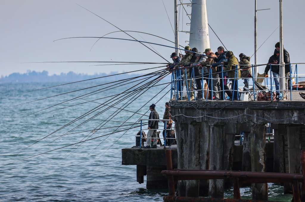 Sukhumi (Georgia), 11/03/2025.- Local people fish on the Black Sea in Sukhumi, the capital of the self-proclaimed republic of Abkhazia, 02 March 2025 (issued 11 March 2025). Abkhazia, a breakaway territory of Georgia since 2008 and recognized by a limited number of countries, including Russia, relies on tourism as a key economic driver. Its Black Sea coastline, with its mild climate and Soviet-era sanatoriums, continues to attract primarily Russian tourists, despite aging infrastructure and remnants of past conflict. (Rusia) EFE/EPA/YURI KOCHETKOV ATTENTION: This Image is part of a PHOTO SET