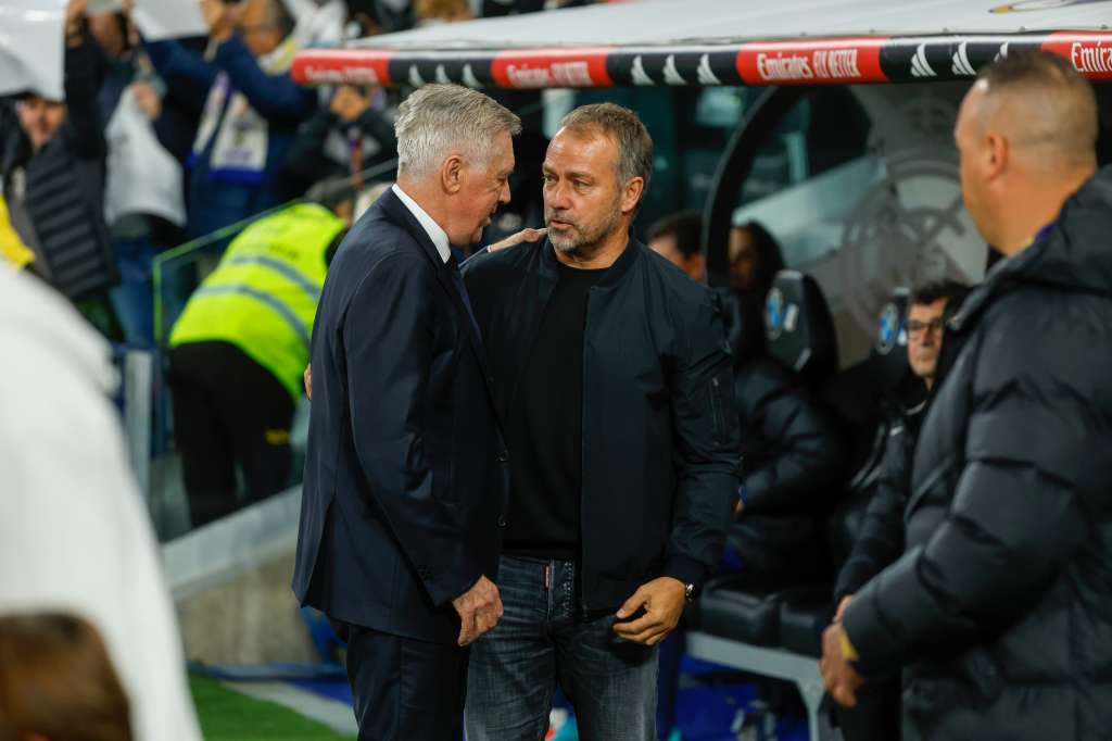 MADRID, 26/10/2024.- El entrenador del Real Madrid Carlo Ancelotti (i) saluda a Hans-Dieter Flick, entrenador del FC Barcelona, previo al partido de la jornada 11 de LaLiga EA Sports entre el Real Madrid y el FC Barcelona, este sábado en el estadio Santiago Bernabéu, en Madrid. EFE/ Juanjo Martín