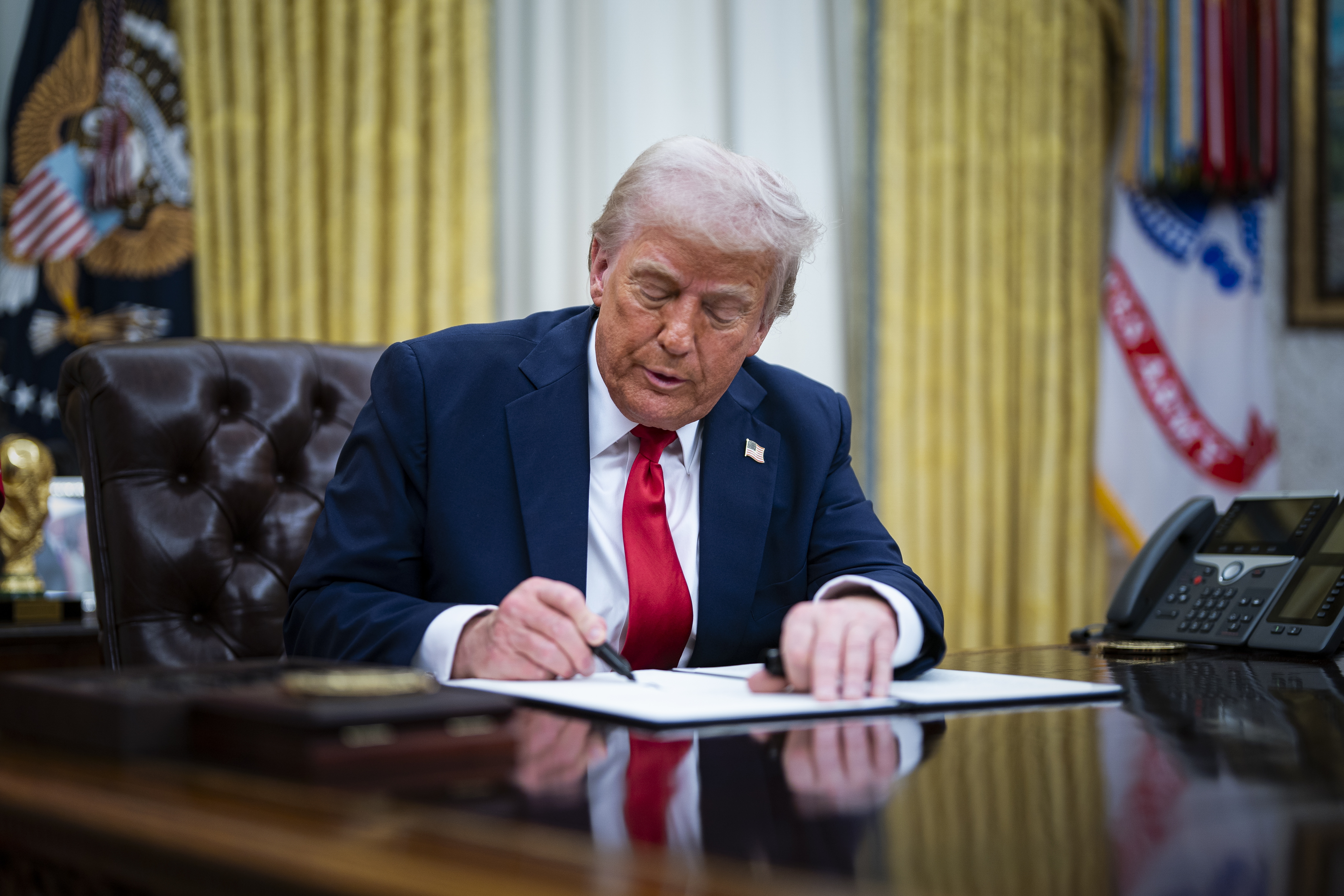 WASHINGTON (United States), 31/03/2025.- US President Donald Trump signs an executive order in the Oval Office at the White House in Washington, DC, USA, 31 March 2025. The order directs the Federal Trade Commission to work with the Department of Justice to ensure that competition laws are enforced in the concert and entertainment industry, and pushes state consumer protection authorities on enforcement. EFE/EPA/ALEXANDER DRAGO / POOL