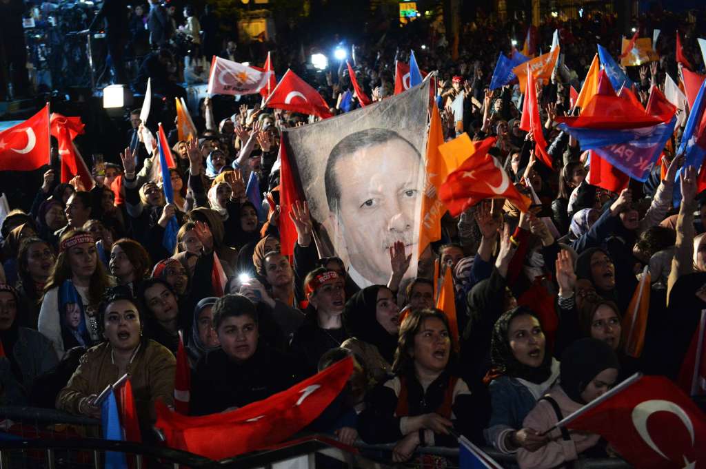 Ankara (Turkey), 15/05/2023.- Supporters wave flags and banners as Turkish President and presidential candidate Recep Tayyip Erdogan makes an address at the Justice and Development Party (AKP) headquarters, in Ankara, Turkey, 15 May 2023, the day after simultaneous parliamentary and presidential elections. (Elecciones, Turquía) EFE/EPA/Necati Savas