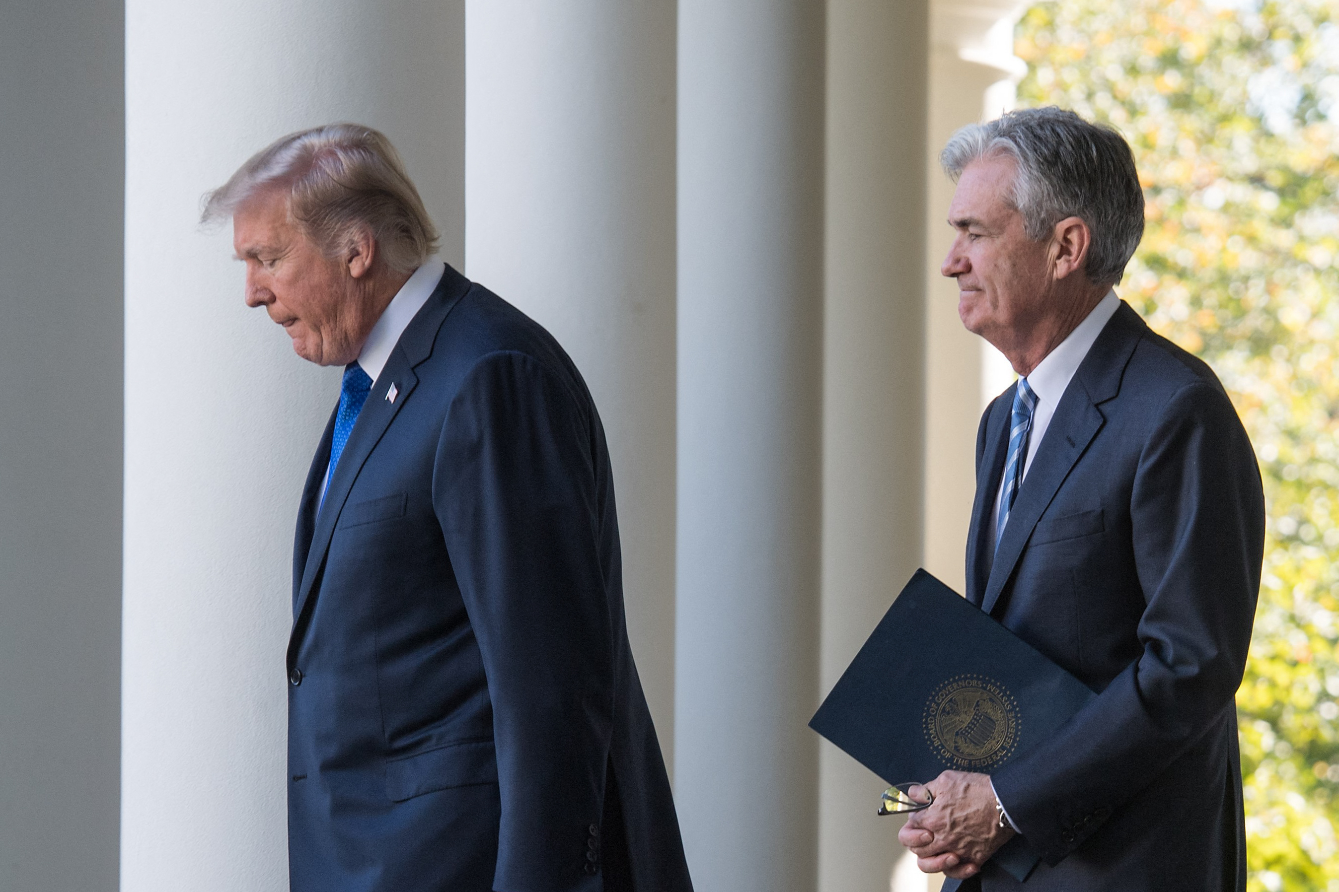 (FILES) US President Donald Trump walks with Jerome Powell, his nominee to be Federal Reserve chairman, at the White House in Washington, DC, on November 2, 2017.