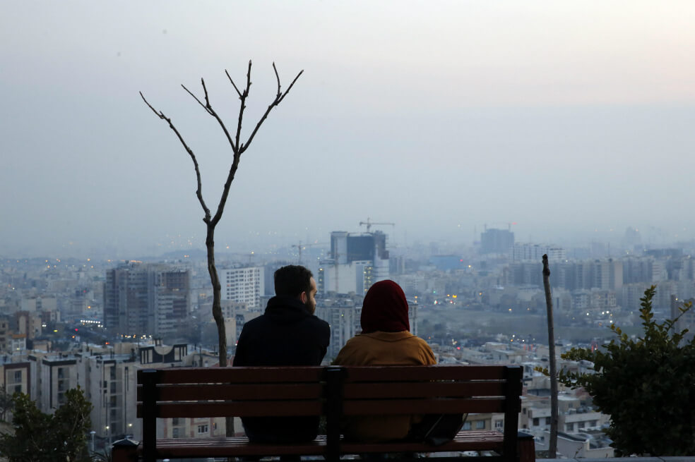 Una pareja iraní se sienta en un banco en un parque durante las crisis pandémicas de coronavirus en Teherán, Irán, 12 de marzo de 2020. / EFE