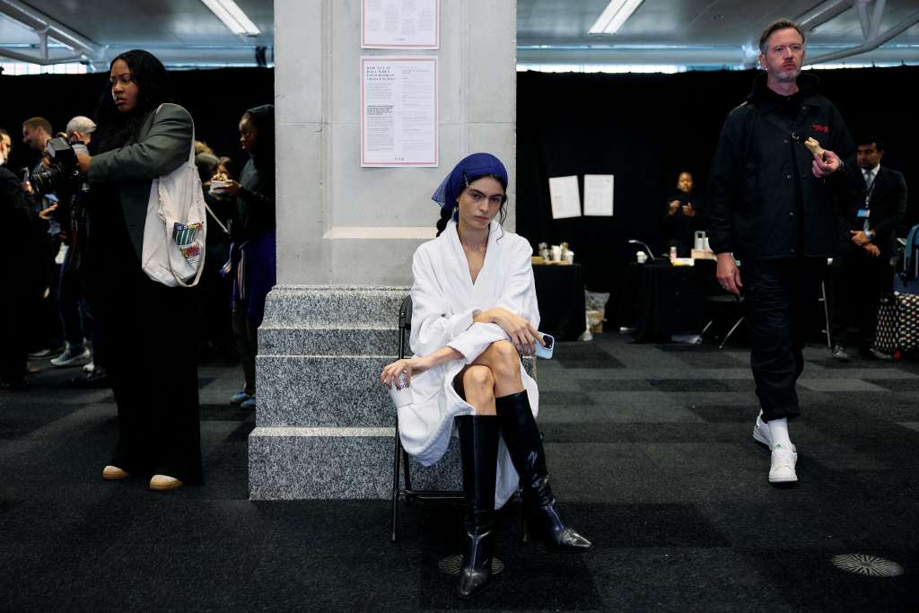 TOPSHOT - A model waits backstage ahead of the JW Anderson Spring/Summer 2025 fashion show during the London Fashion Week, in London, on September 15, 2024. (Photo by BENJAMIN CREMEL / AFP)