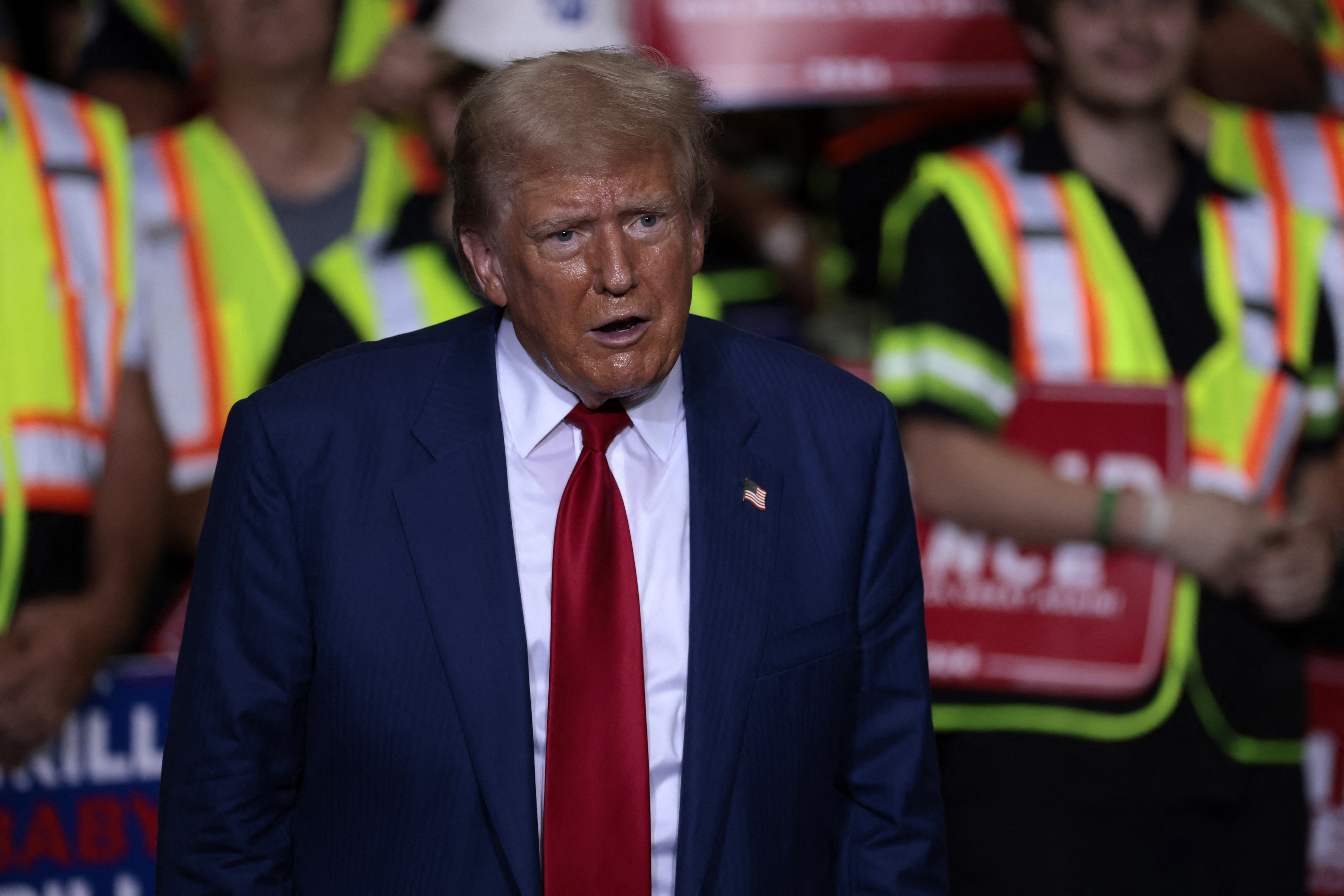 Former US President and Republican presidential candidate Donald Trump arrives to speak about the economy during a campaign event in Potterville, Michigan, on August 29, 2024. (Photo by JEFF KOWALSKY / AFP)