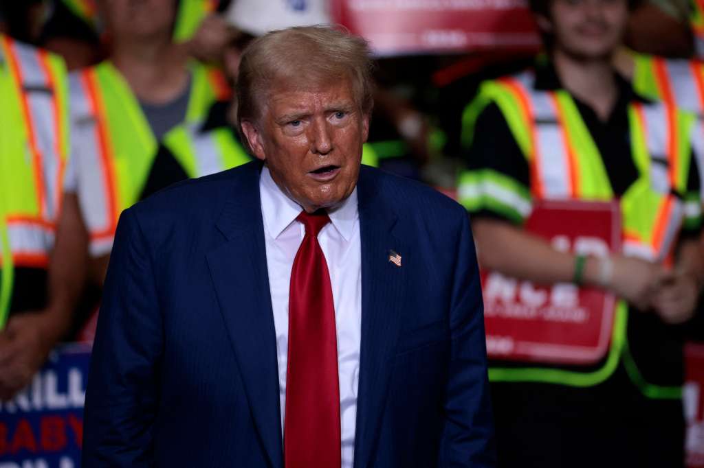 Former US President and Republican presidential candidate Donald Trump arrives to speak about the economy during a campaign event in Potterville, Michigan, on August 29, 2024. (Photo by JEFF KOWALSKY / AFP)