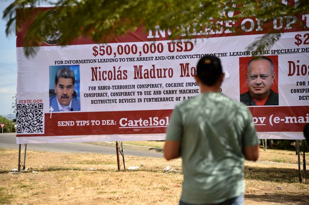 Un hombre mira una pancarta que ofrece una recompensa por información que conduzca al arresto del presidente venezolano Nicolás Maduro y del ministro de Relaciones Interiores, Justicia y Paz de Venezuela, Diosdado Cabello, en Villa del Rosario, Norte de Santander.